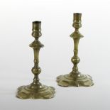A pair of George III brass candlesticks, with knopped stems,