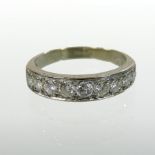 An 18 carat gold and diamond set half hoop eternity ring, approximately 1.