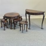 An early 20th century hardwood nest of occasional tables, 66cm diameter,