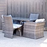 A rattan garden table with a glass top, 120 x 60cm,