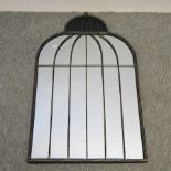 An iron framed wall mirror, of birdcage design,