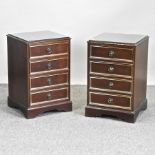 A pair of bedside cabinets, with glass tops,