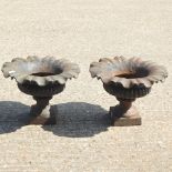 A pair of cast iron garden urns,
