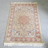 A Turkish woollen rug, with a central medallion and foliate designs, on a pale blue ground,