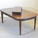 A mahogany wind-out dining table, with two additional leaves and winder,