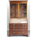 A George III mahogany bureau bookcase, on bracket feet,