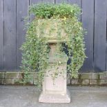 A reconstituted stone garden urn, on stand,