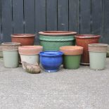 A collection of terracotta and glazed garden pots,