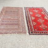 A Persian rug, with four central medallions, on a red ground, 230 x 120cm,
