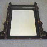 A Victorian ebonised and gilt decorated wall mirror,