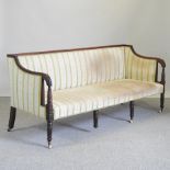 A Regency carved mahogany sofa, on reeded legs,