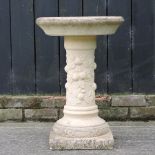 A reconstituted stone bird bath, on a column base,