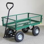 A green painted metal garden cart,