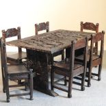 An African carved hardwood dining table, decorated with figures, 143 x 93cm,