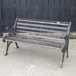 A hardwood garden bench, with cast iron ends,