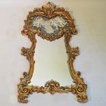 A gilt framed wall mirror, decorated with a cherub,