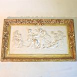 A reproduction plaque of cherubs, in a gilt frame,