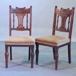 A set of eight Edwardian carved walnut dining chairs, with gold upholstered seats,