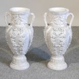 A pair of white plaster garden urns,
