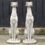 A pair of reconstituted stone garden models of whippets,