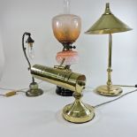 A brass desk lamp, together with two others smaller and a Victorian brass oil lamp,