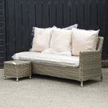 A beige three seater garden sofa, 173cm, with loose cushions,