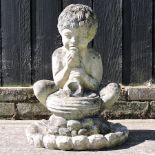 A stone garden figure of a cherub,