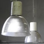 A pair of industrial ceiling lights, with holophane style shades,