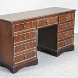 A reproduction mahogany desk,