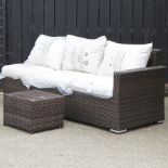 A brown rattan three seater sofa, 200cm, with loose cushions,