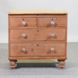 An antique pine chest of drawers, on turned feet,