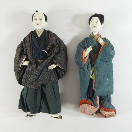 An early 20th century Japanese costume doll, in traditional dress, together with another,