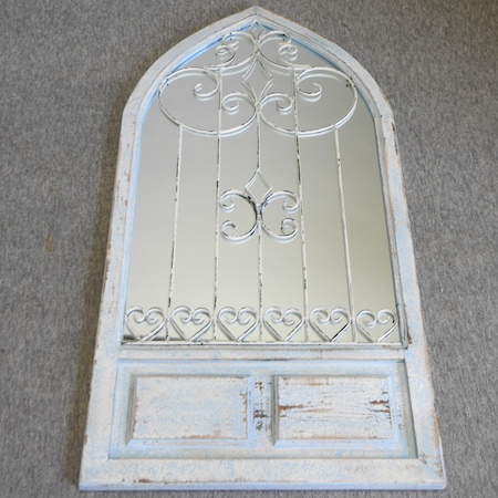 A blue painted arched wall mirror,