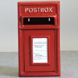 A GPO style red painted metal post box,