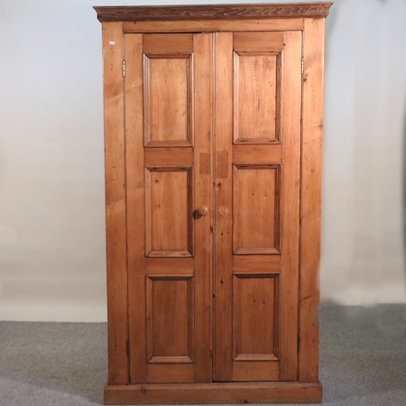 An antique pine hall cupboard,