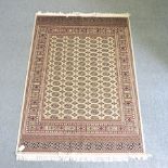 A Bokhara style rug, with all over design, on a cream ground,