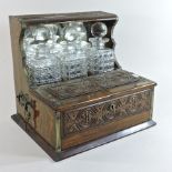 A 19th century carved oak and brass mounted tantalus,