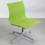 A 1970's Eames green upholstered revolving desk chair, on a steel base,