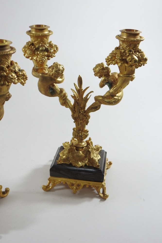 A pair of continental gilt bronze two branch table candelabra, decorated with fruit and putti, - Image 7 of 8