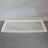 A white painted wall mirror,