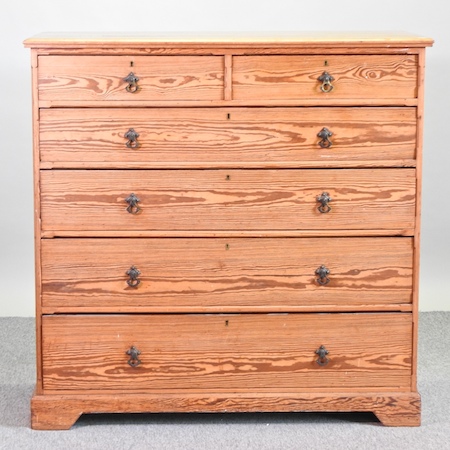 A large 19th century pitch pine chest of drawers,