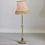 A 19th century brass telescopic standard lamp and shade