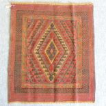 A Turkish woollen rug, with a central diamond,