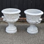 A pair of reconstituted stone garden urns,