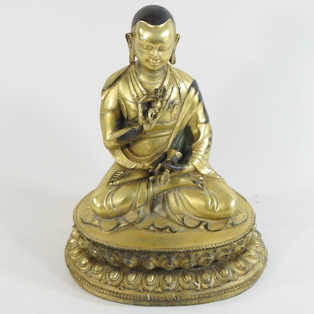 A gilt bronze figure of a seated deity,