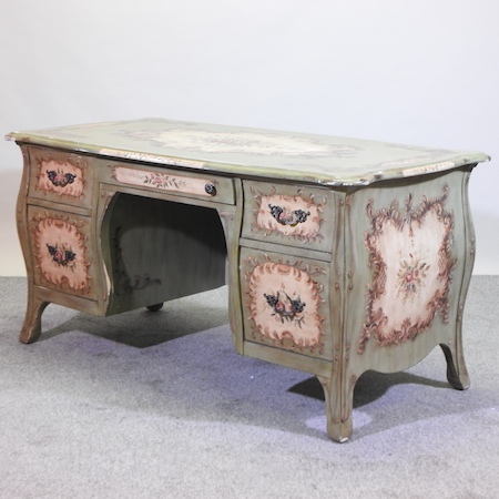 A Venetian style green painted desk, with floral decoration,