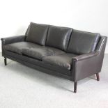 A 1960's Danish black leather upholstered three seater sofa,