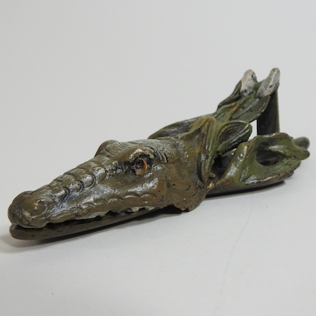A novelty bronze paper clip, in the form of a crocodile,