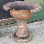 A Victorian painted cast iron garden urn, on a pedestal base,
