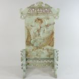 A Chinese jade coloured carved stone table screen, decorated with a figure,